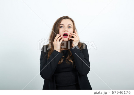Shocked Female Holds Hands To Face And Reacts Emotionally. Human Fear, Surprise Shocked Female Holds Hands To Face And Reacts Emotionally. Human Fear, Surprise 67946176