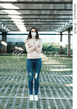 Young girl in medical mask and gloves shows stop sign Young girl in medical mask and gloves shows stop sign 67946289