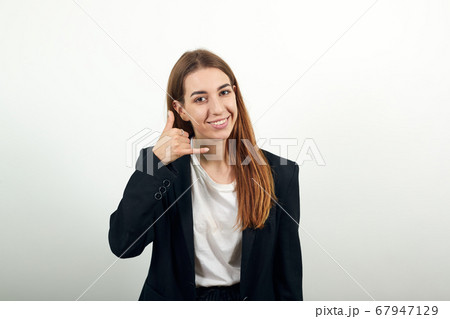 Imitates telephone conversation, keeps hand near ear if holding mobile phone. 67947129