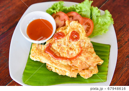 Omelet roll with sliced tomatoes salad lettuce Omelet roll with sliced tomatoes salad lettuce 67948616