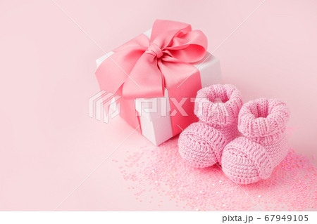 Close up of baby shoes, present gift box - 67949105