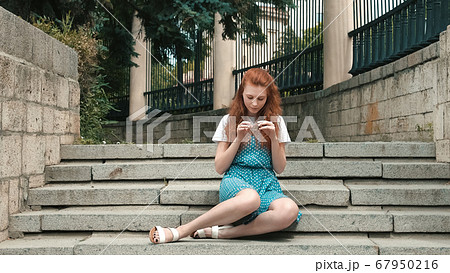 Ginger woman hold strobile in her hand. 67950216