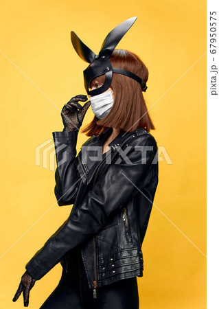 Female rabbit mask posing sexually in a medical mask from coronavirus 67950575