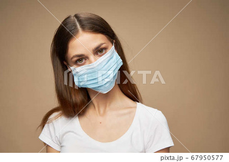 Young woman stylish clothes in a medical mask covid-19 epidemic  67950577