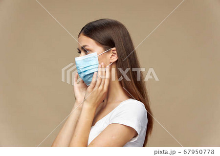 Beautiful woman fashion clothes in a protective mask  67950778
