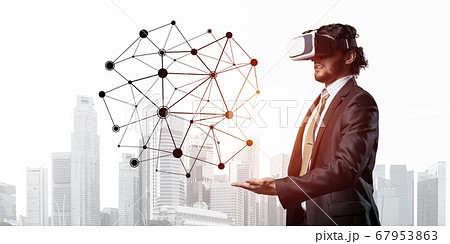 Handsome businessman experiencing impressive virtual reality connection concept 67953863