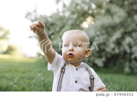 Outdoor portrait of baby boy in park 67956352