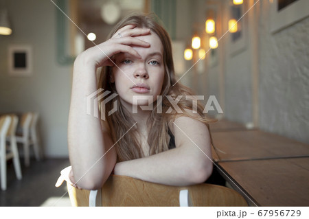 Portrait of young woman with long blond hair 67956729