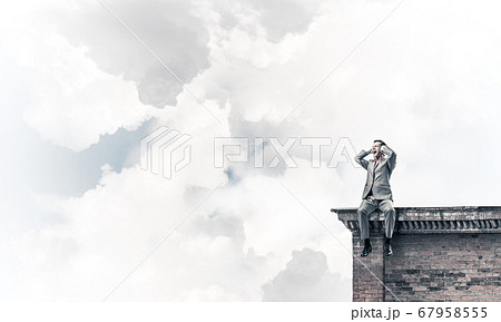 Young man on building roof dont want to hear anything Young man on building roof dont want to hear anything 67958555
