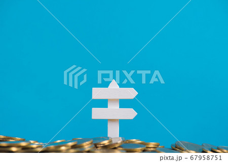 Pile of golden coins and white wooden board sign, 67958751
