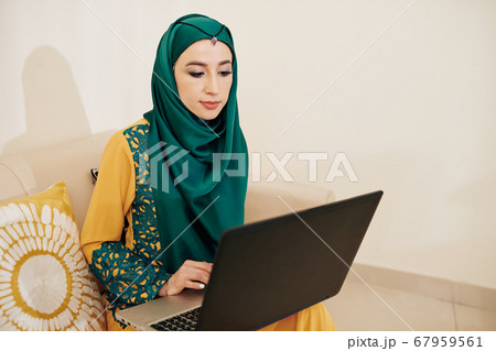 Muslim woman working on lapotp Muslim woman working on lapotp 67959561