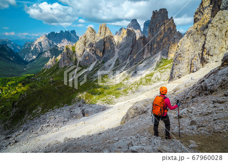 Woman hiker with backpack on the hiking trail, Dolomites, Italy 67960028