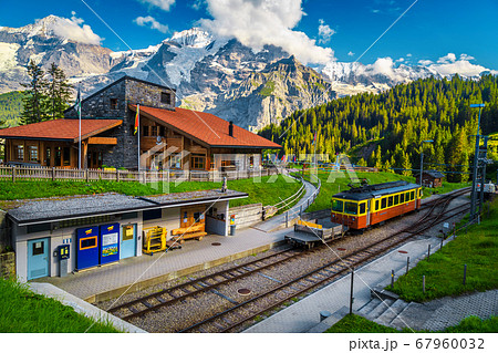 Railway station with mountains and retro tourist train, Murren, Switzerland   67960032