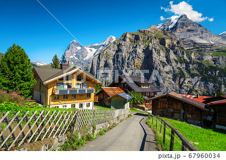 Wooden lodges and flowery gardens in Murren mountain resort, Switzerland Wooden lodges and flowery gardens in Murren mountain resort, Switzerland 67960034