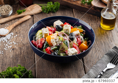 Closeup on fresh greek salad in a black bowl 67960337