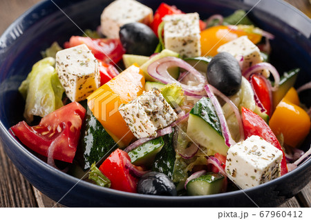 Closeup on fresh greek salad in a black bowl 67960412