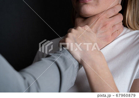 Victim, abuse and domestic violence - Woman being abused and strangled by strong man 67960879
