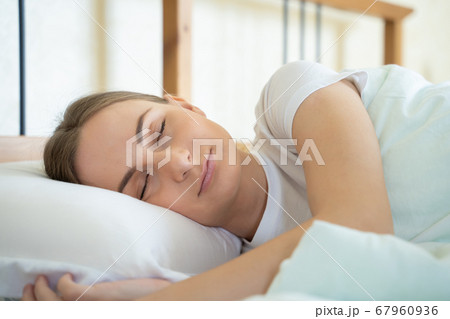 Woman sleeping in her bed and relaxing in the morning 67960936