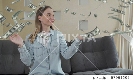 Cash money falling on happy surprised woman, favorable bank loan terms 67961505
