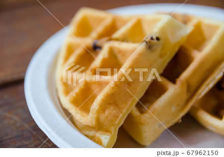 waffles on plate on wooden table 67962150