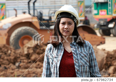Female civil engineer with white helmet, standing 67962734