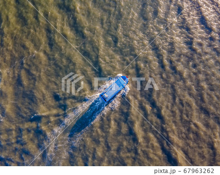 Top view of a boat sailing to the sea or river Top view of a boat sailing to the sea or river 67963262