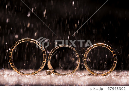 gold wedding rings on an abstract background with copy space 67963302