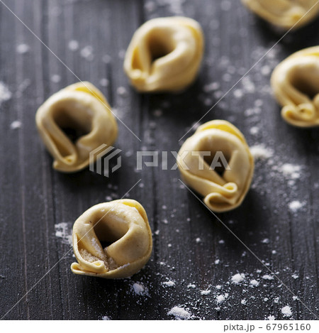 Raw italian tortellini on the wooden table 67965160