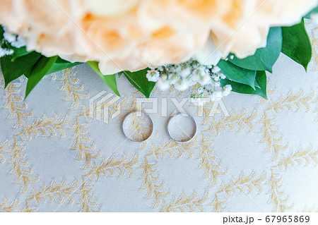 Beautiful wedding rings lie on light surface 67965869