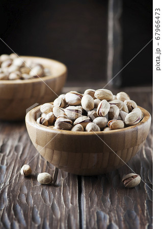 Salt pistachio nuts in the wooden bowl 67966473