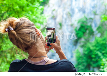 nature photography with the help of a smartphone by a young tourist on a trip 67967276