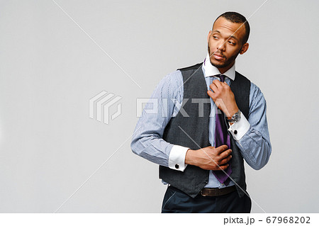 Young adult afro american businessman with tired and sick expression studio shot Young adult afro american businessman with tired and sick expression studio shot 67968202