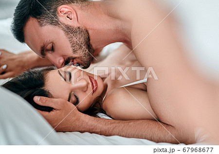The passionate man and woman playing in the bed The passionate man and woman playing in the bed 67968677