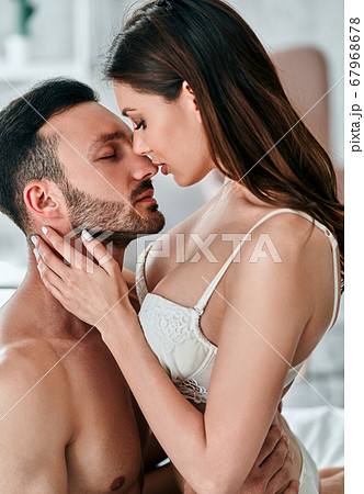 The passionate man and woman playing in the bed The passionate man and woman playing in the bed 67968678