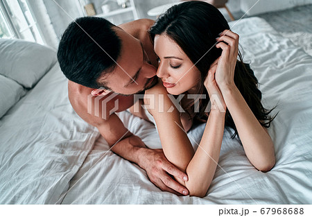 The couple in underwear laying in the bed - Stock Photo [67968688