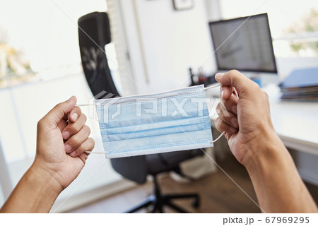 man at work about to put on a face mask 67969295