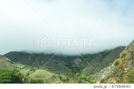 fog over a green hill in California fog over a green hill in California 67969640