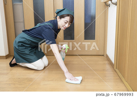 床の清掃をするハウスクリーニングの女性作業員 67969993