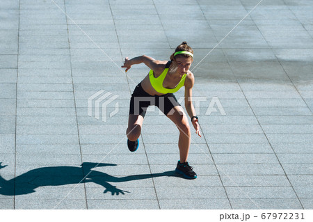 Female runner, athlete training outdoors in summer's sunny day. Female runner, athlete training outdoors in summer's sunny day. 67972231