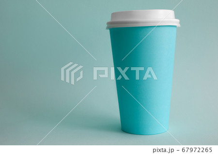 There is turquoise glass of coffee on table There is turquoise glass of coffee on table 67972265