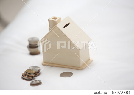 saving the money into the house on the bed 67972301