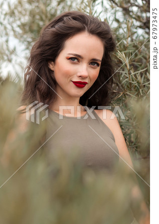 Charming woman in park in summer Charming woman in park in summer 67973475