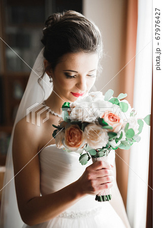 Beautiful fashion bride in wedding dress posing Beautiful fashion bride in wedding dress posing 67976427