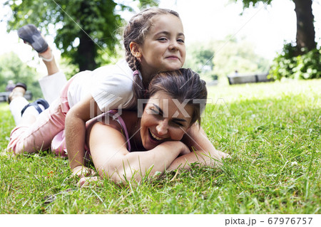 young pretty mother walking with little cute daughter outside in green park, lifestyle poeple concept young pretty mother walking with little cute daughter outside in green park, lifestyle poeple concept 67976757