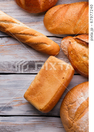 Flat lay various bread loaves on wooden background. Flat lay various bread loaves on wooden background. 67977240