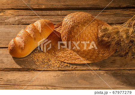 Wheat grain, baguette, straw hat and spikelets. Wheat grain, baguette, straw hat and spikelets. 67977279