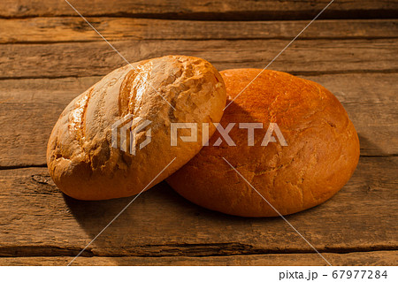 Two round loaves of homemade bread. Two round loaves of homemade bread. 67977284