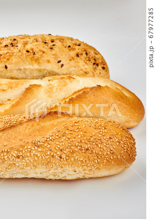 Three different baguettes on white background. Three different baguettes on white background. 67977285