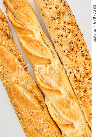 Three baguettes on white background. 67977288
