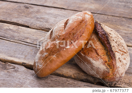 Traditional wheat bread on wooden background. Traditional wheat bread on wooden background. 67977377